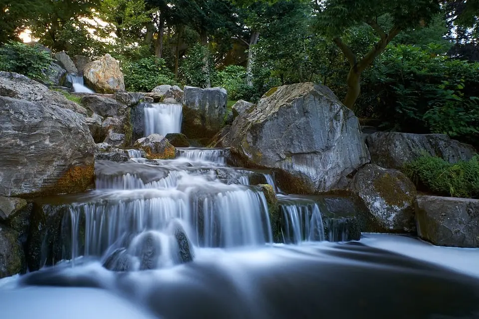 Serene waterfall surrounded by rocks and lush greenery in Bosnia.